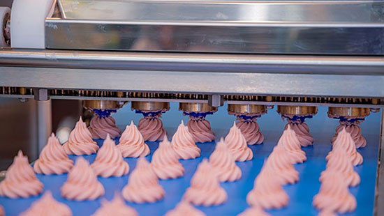 cakes on a conveyor belt