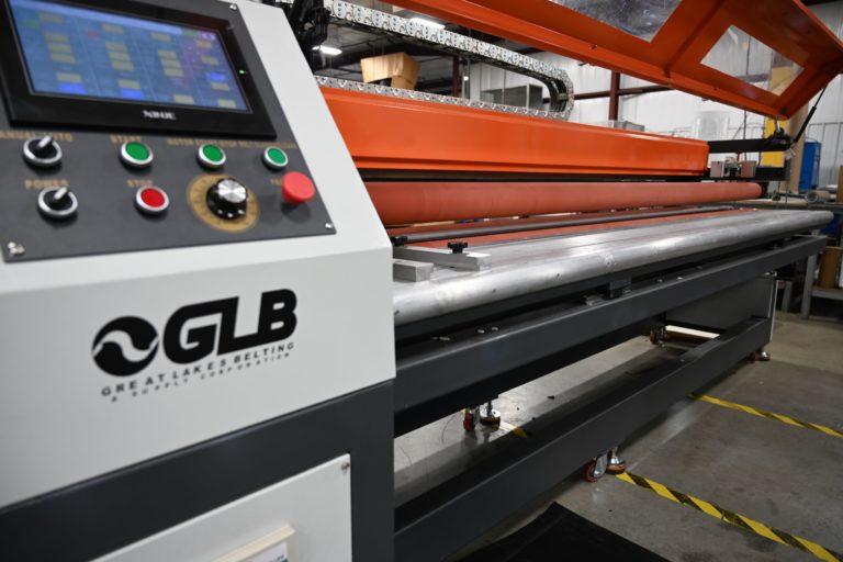 A Great Lakes Belting branded conveyor belt perforation machine.