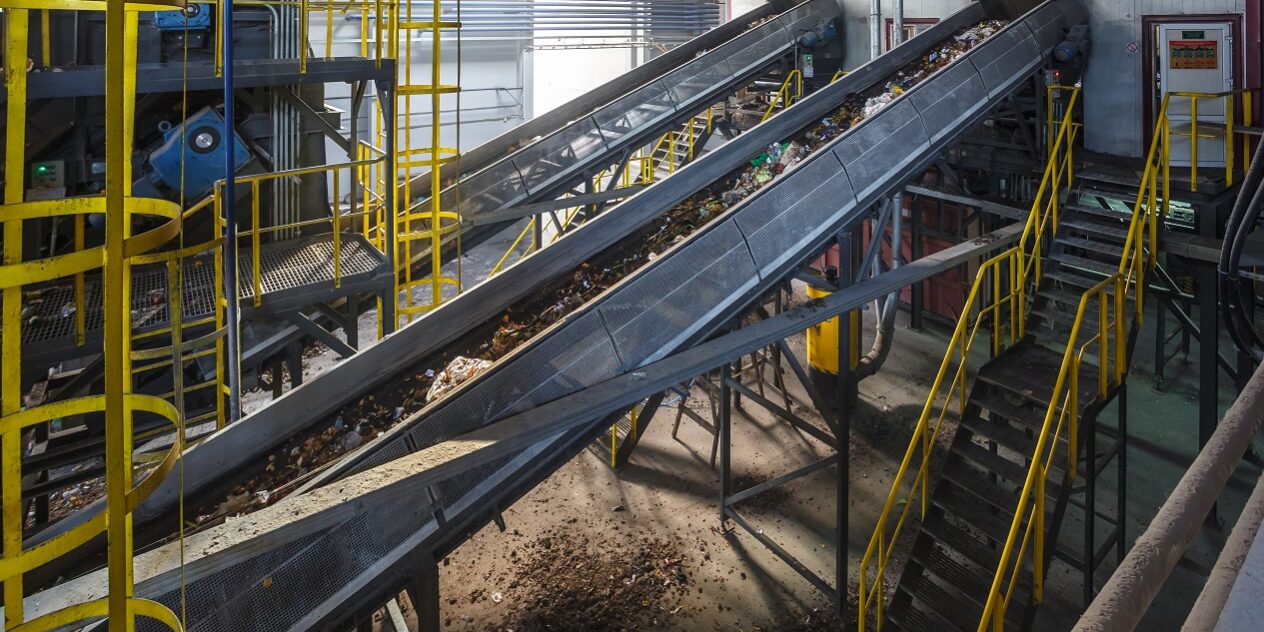 A recycling conveyor belt in a modern recycling processing plant.