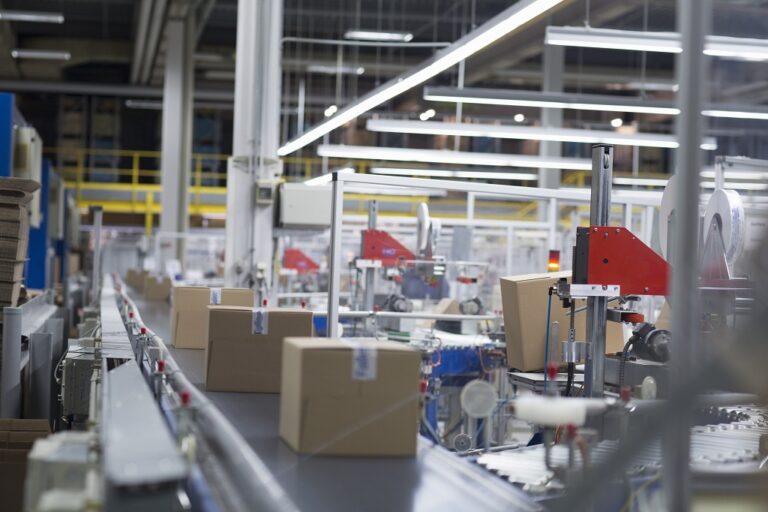 Boxes move on a production conveyor belt at a paper packaging factory.