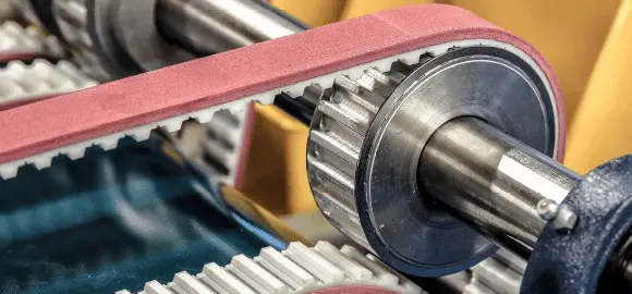 A close-up of a timing belt with a rubber backing.