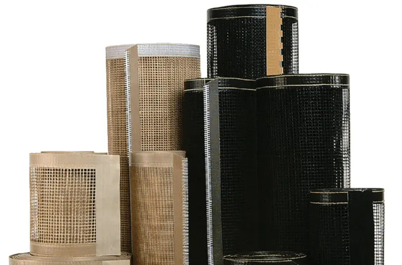 Stacks of rolled tan and black DuraFlow Mesh Belts from AFC.